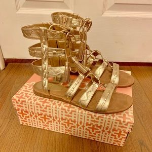 Gold strappy sandal.